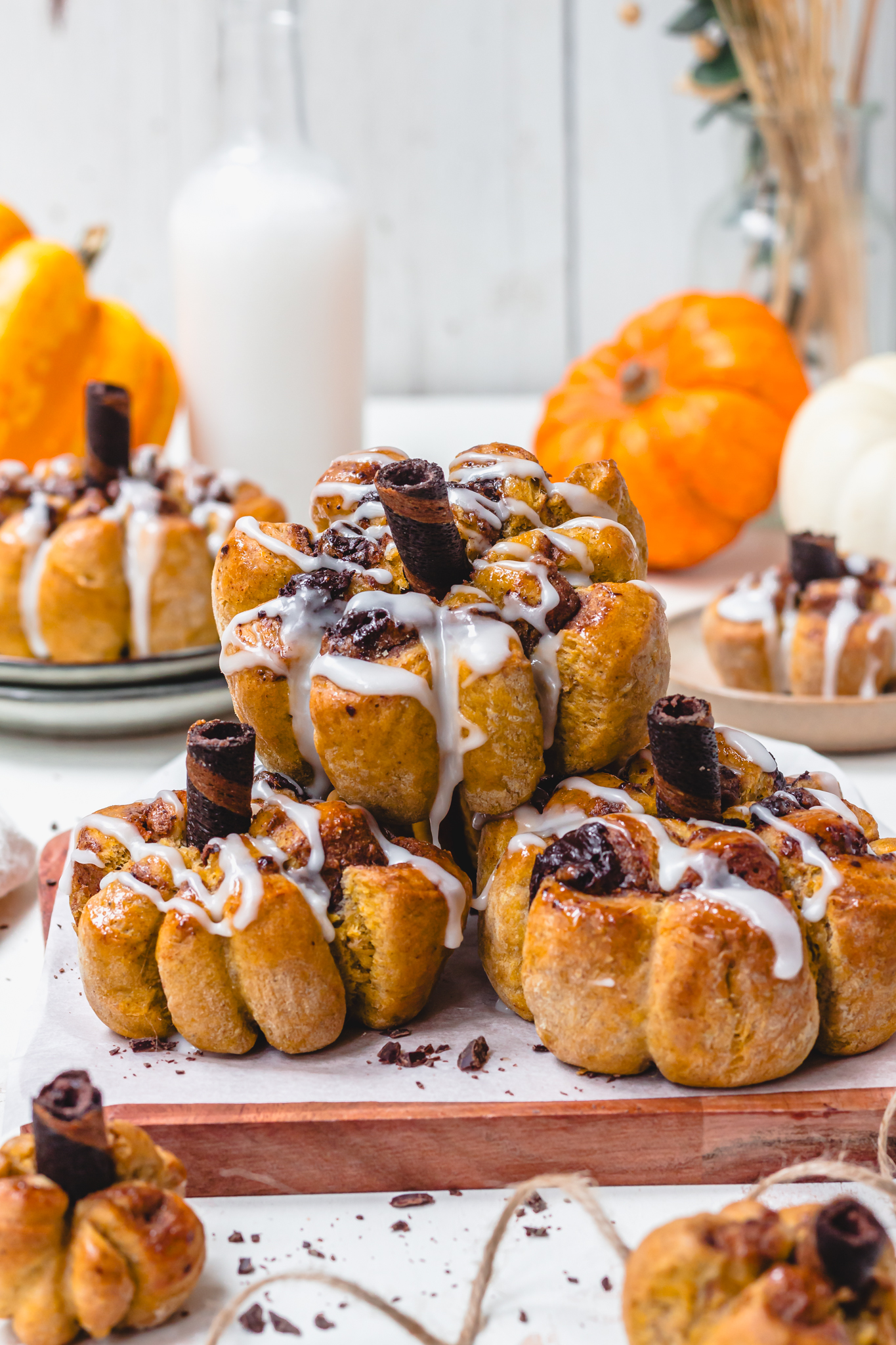 A few Pumpkin-Shaped Chocolate Cinnamon Rolls stacked on one another