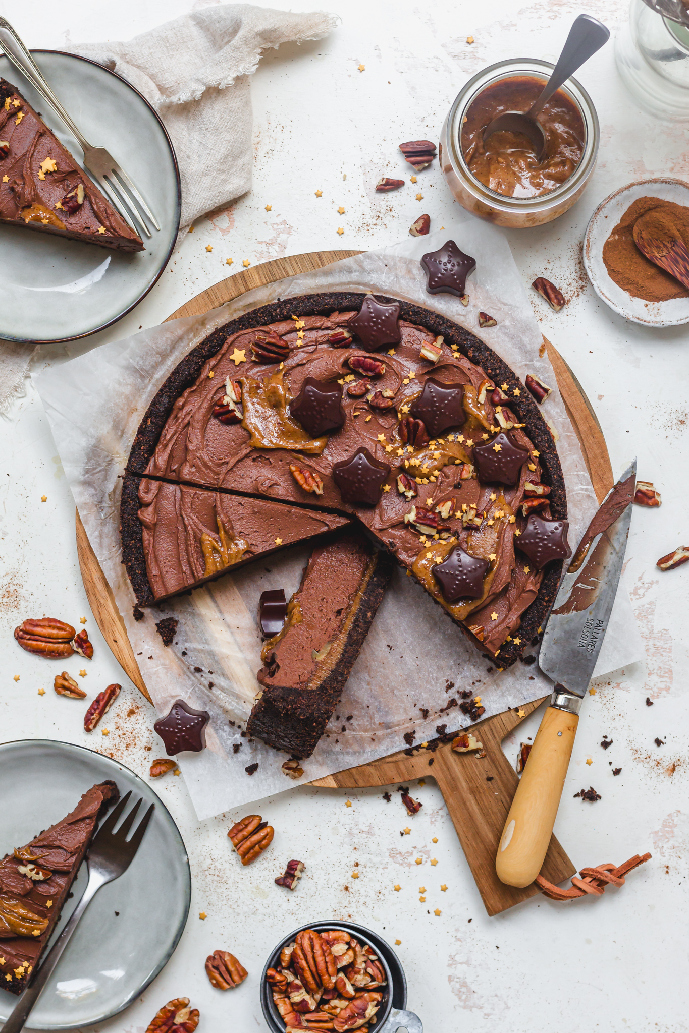 A Chocolate Pecan Caramel Cheesecake with slices removed