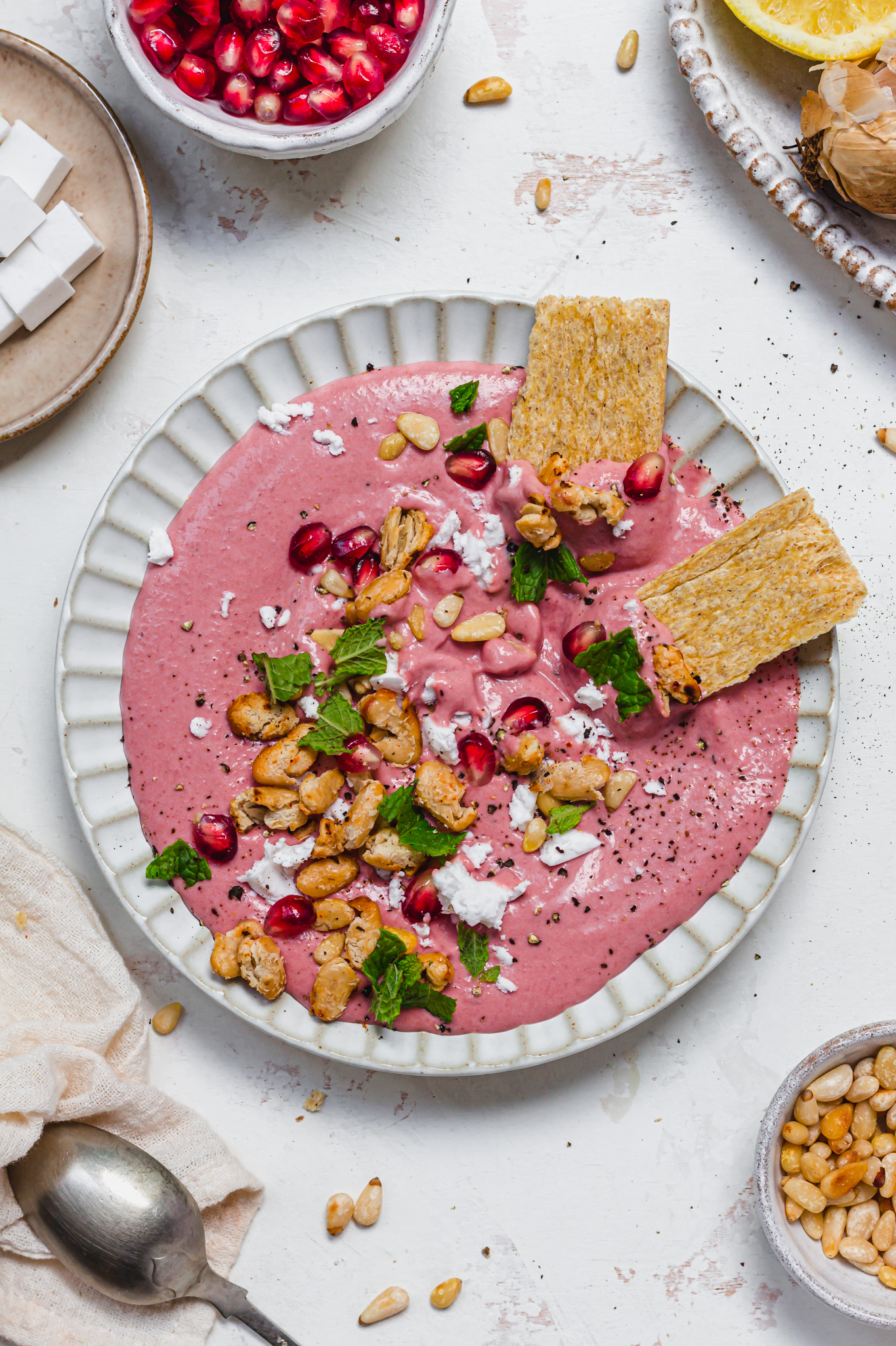 A plate of Creamy Beetroot Bean Dip with crackers