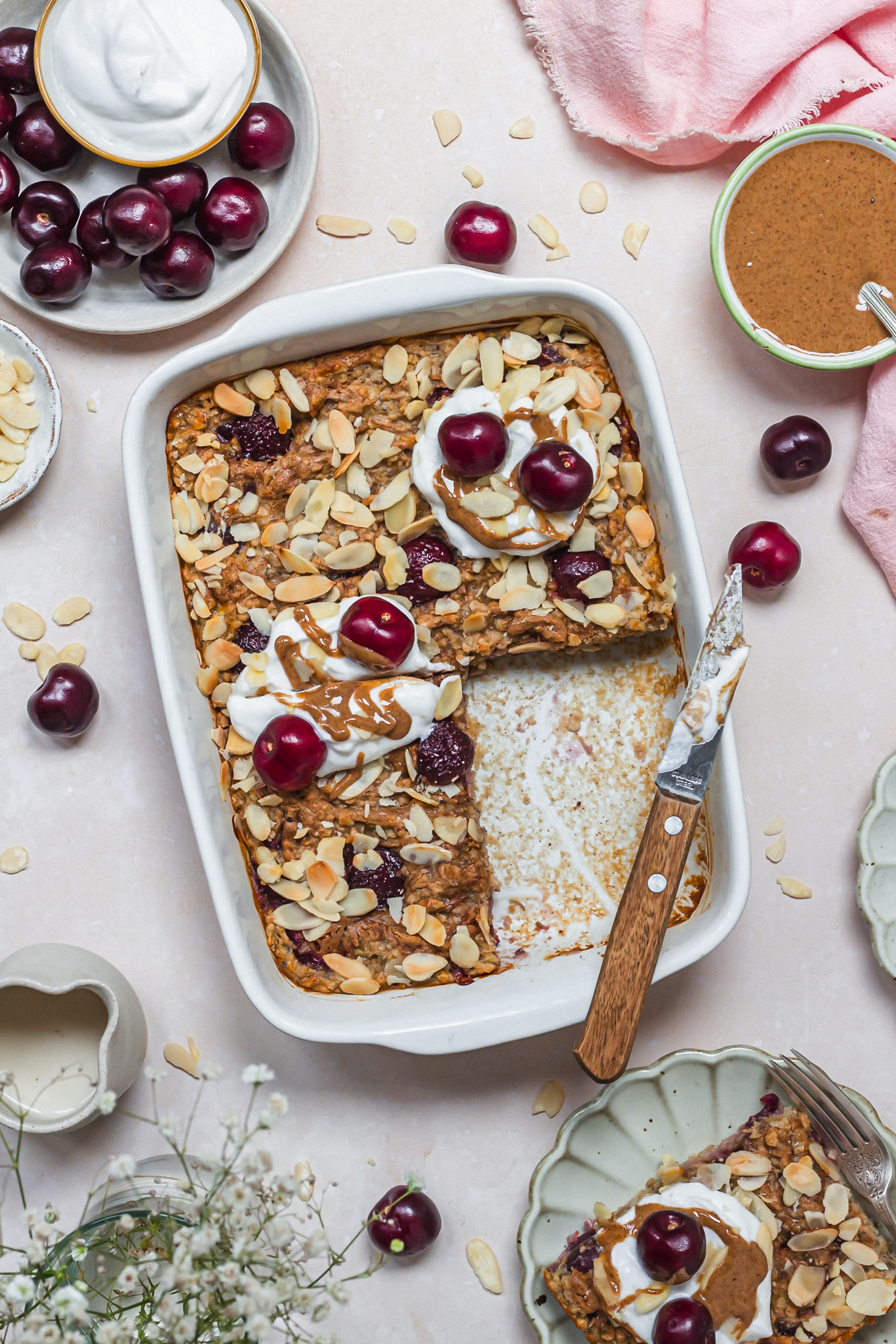 A dish of Cherry Almond Baked Oats with one slice removed