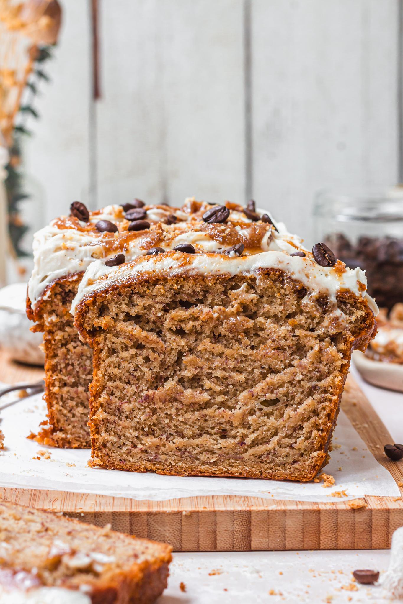 A slice of Caramel Latte Banana Bread leaning against a loaf