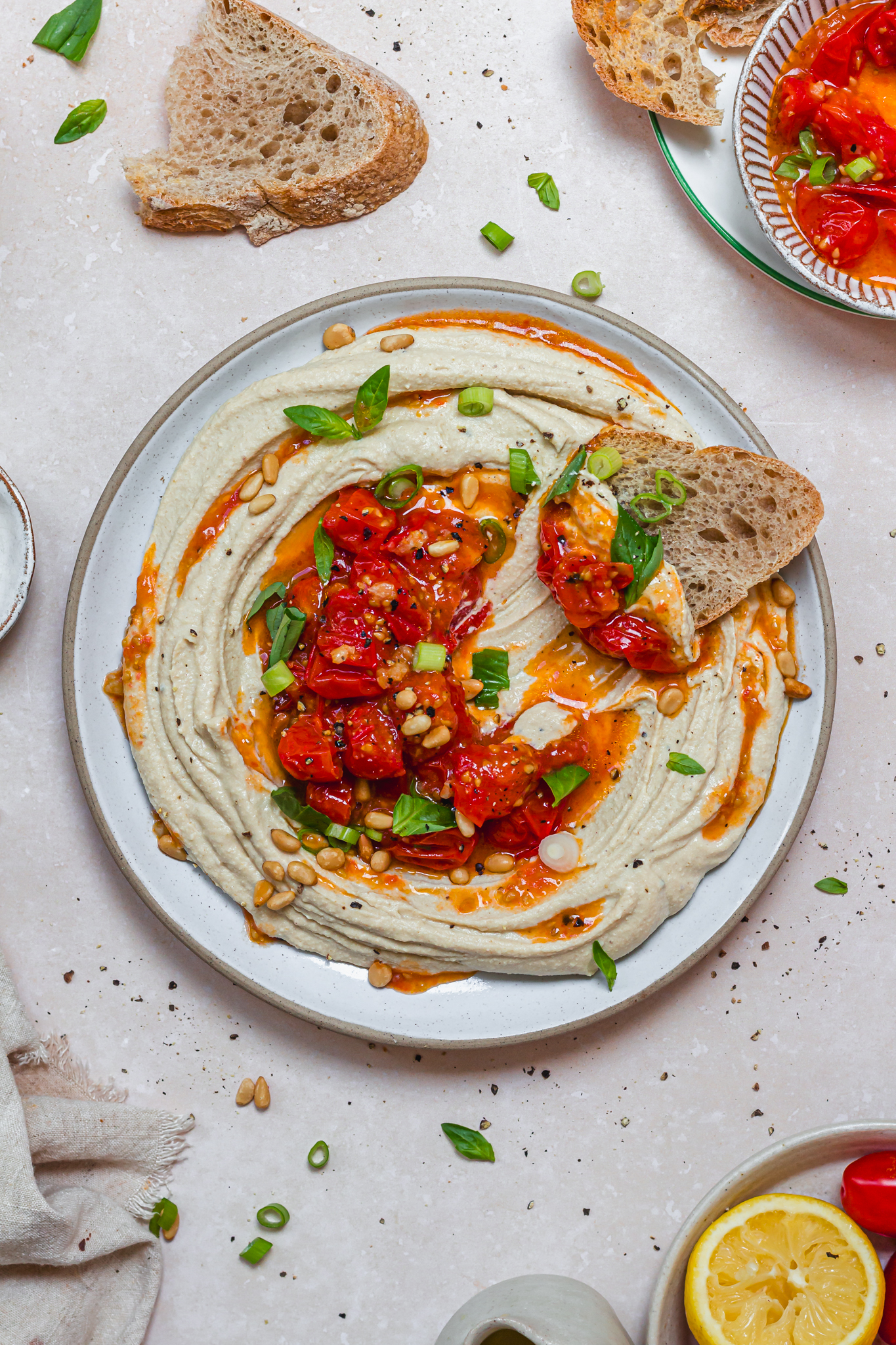 Bread and a plate of dip with tomatoes