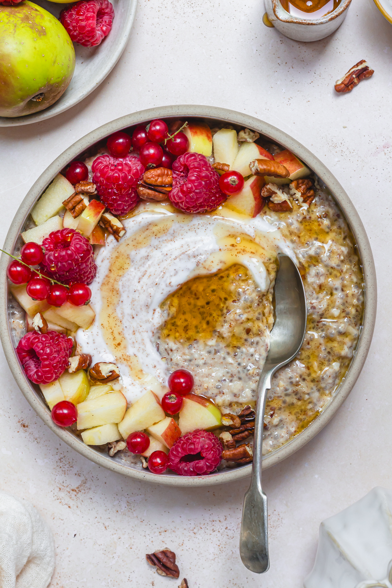 A bowl of Cinnamon Apple Quick Soak Overnight Oats with a spoon