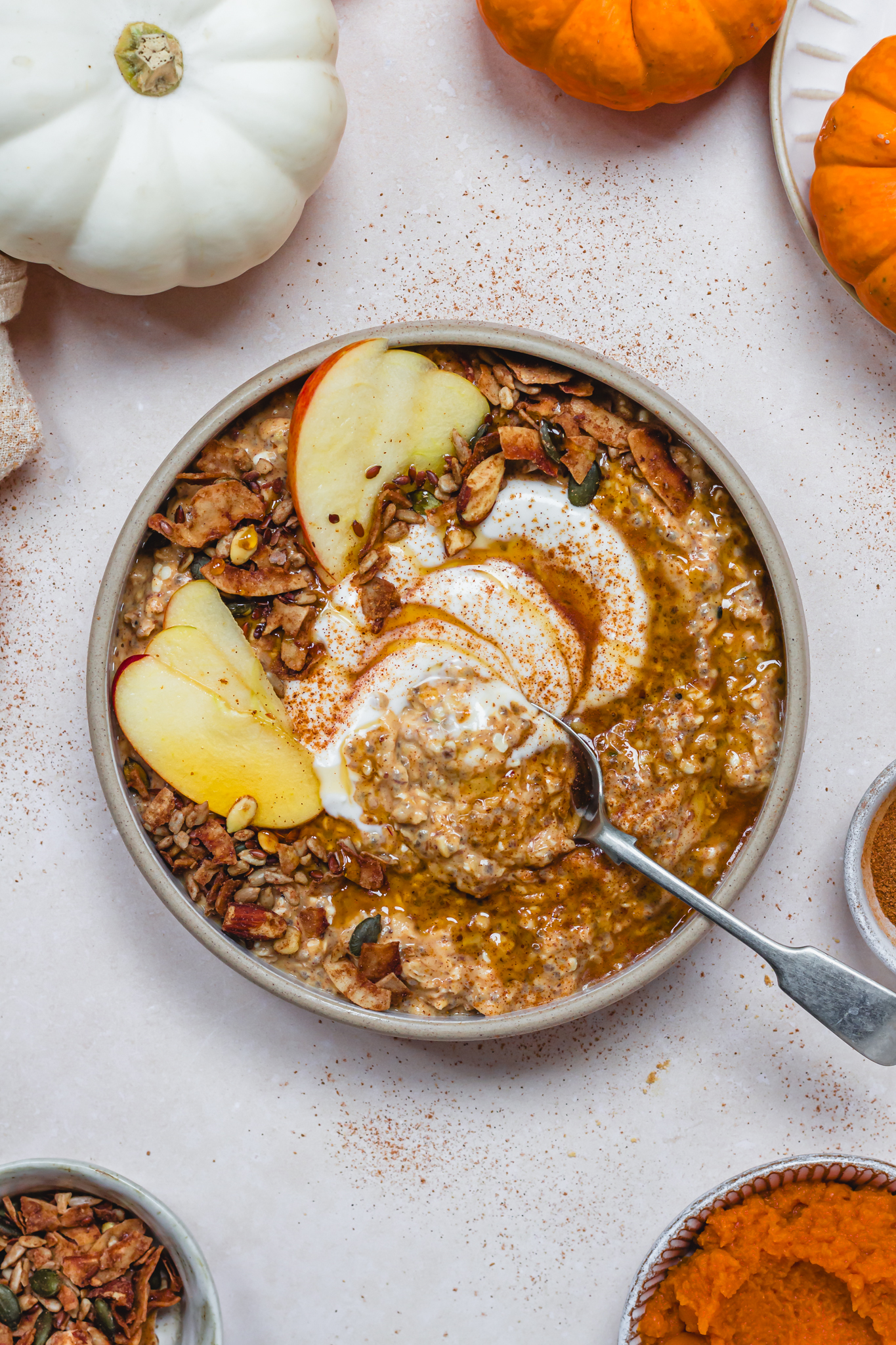 A bowl of Pumpkin Spice Quick Soak Overnight Oats with a spoon