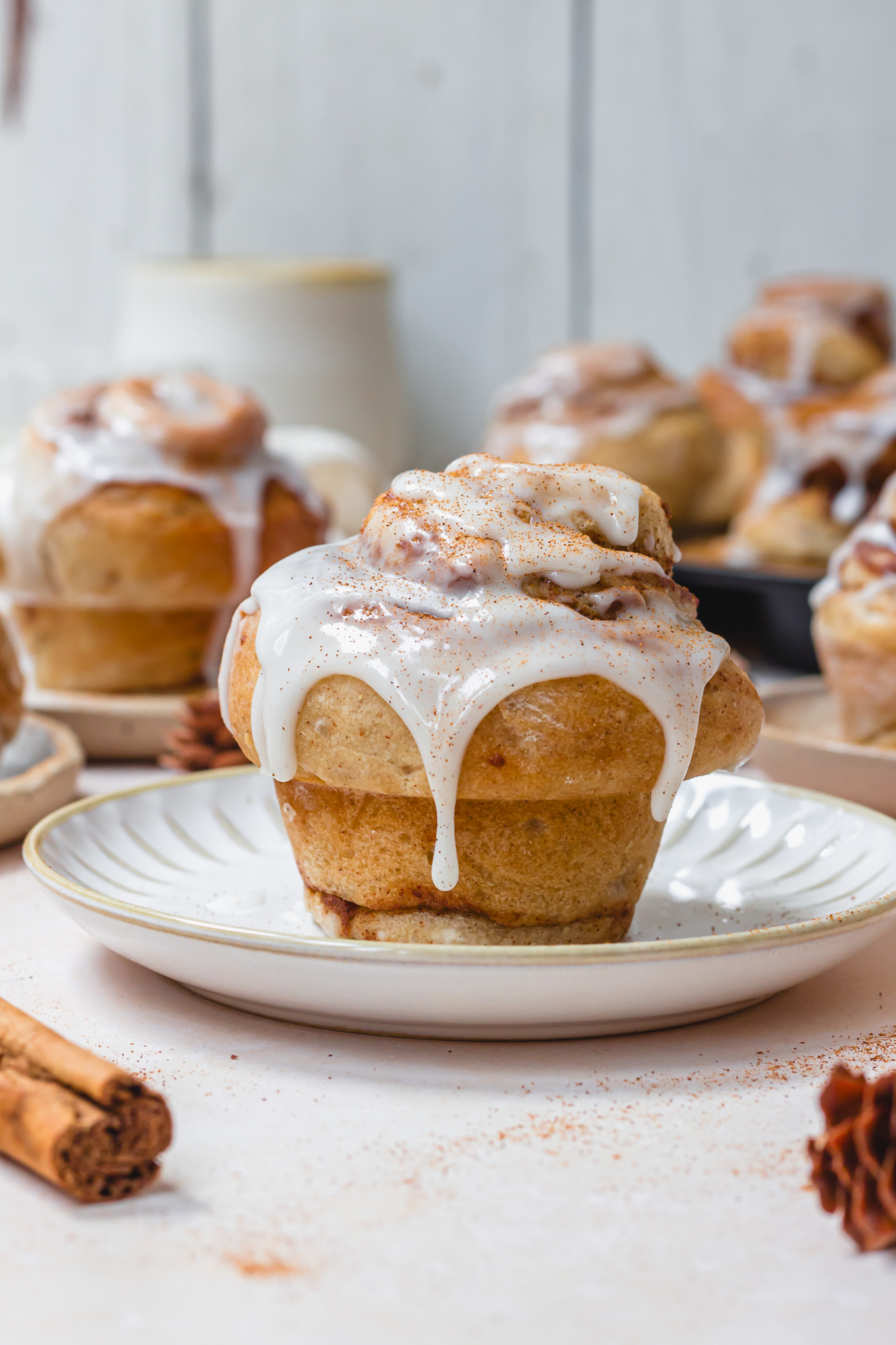 Cinnamon Roll Muffin on a plate with icing sugar