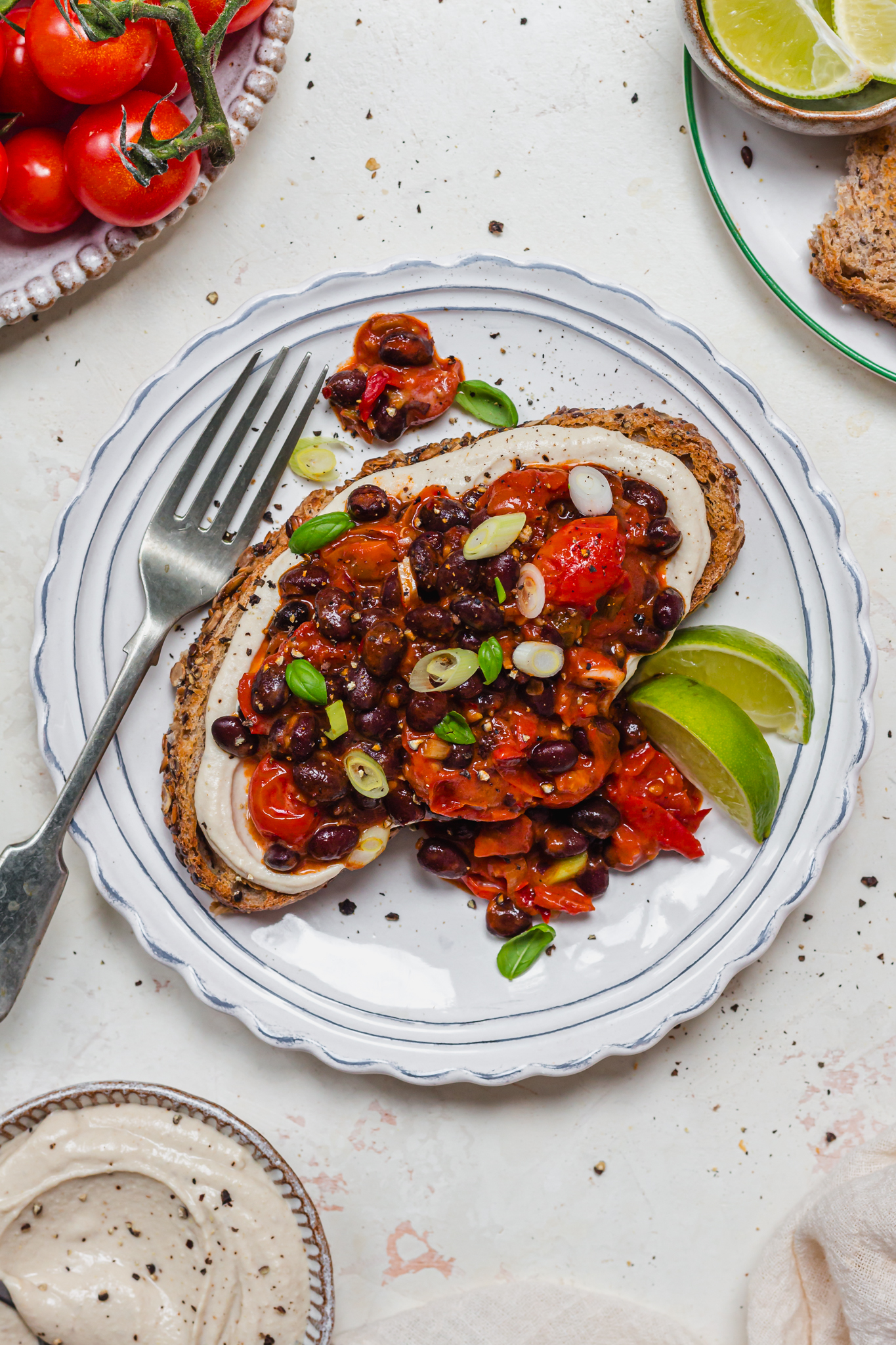 Harissa Black Beans and Hummus Toast with a fork