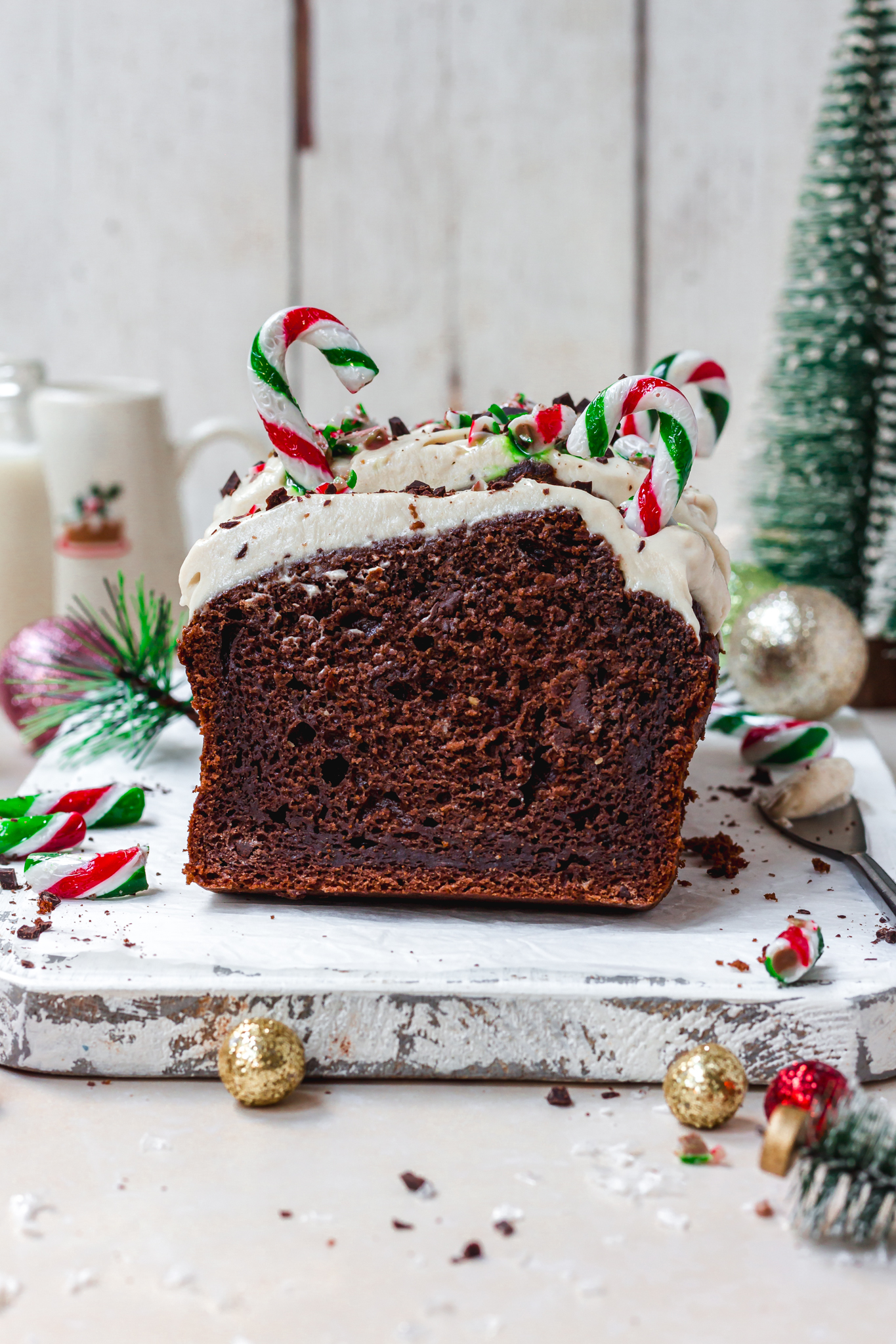 Chocolate Peppermint Candy Cane Banana Bread on a white wooden board