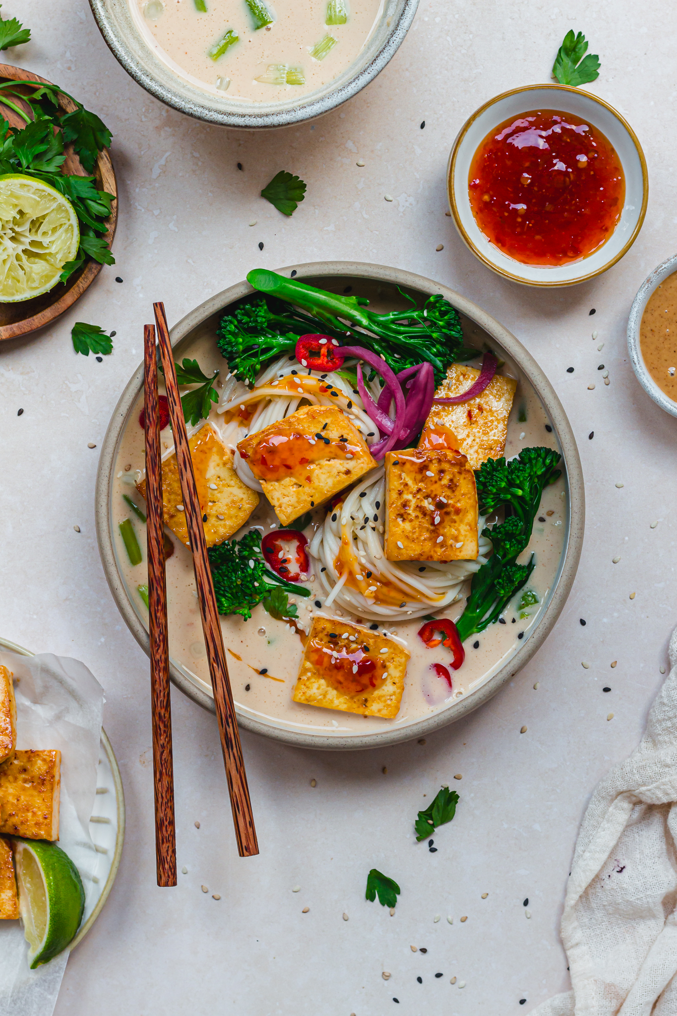 A bowl of Spicy Peanut Tofu Noodle Soup with chopsticks