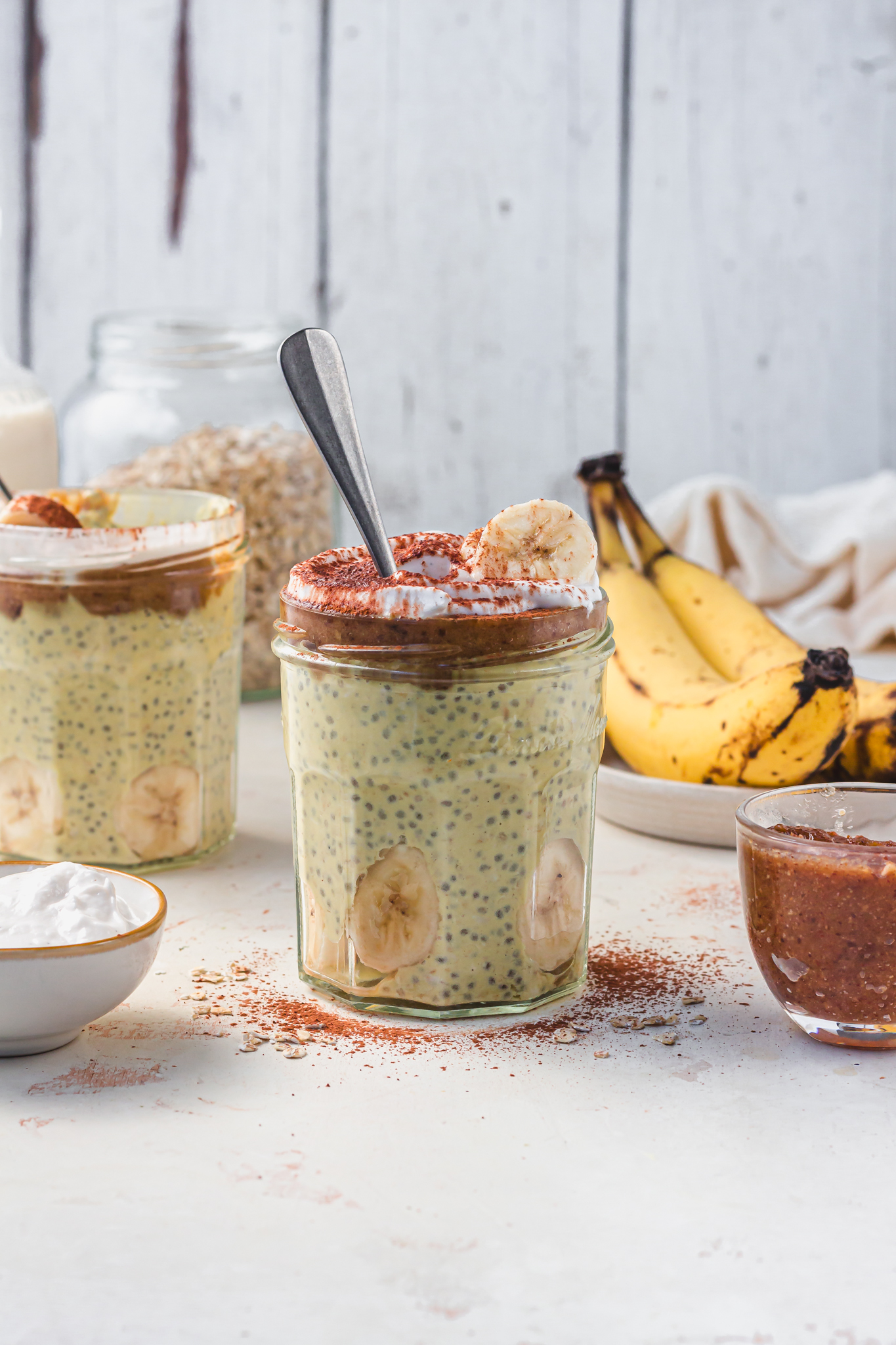 A jar of Banoffee Breakfast Overnight Oats with a spoon