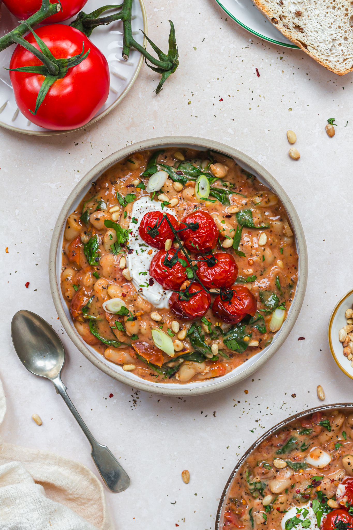 A bowl of Sun-Dried Tomato and Spinach Beans with roasted tomatoes