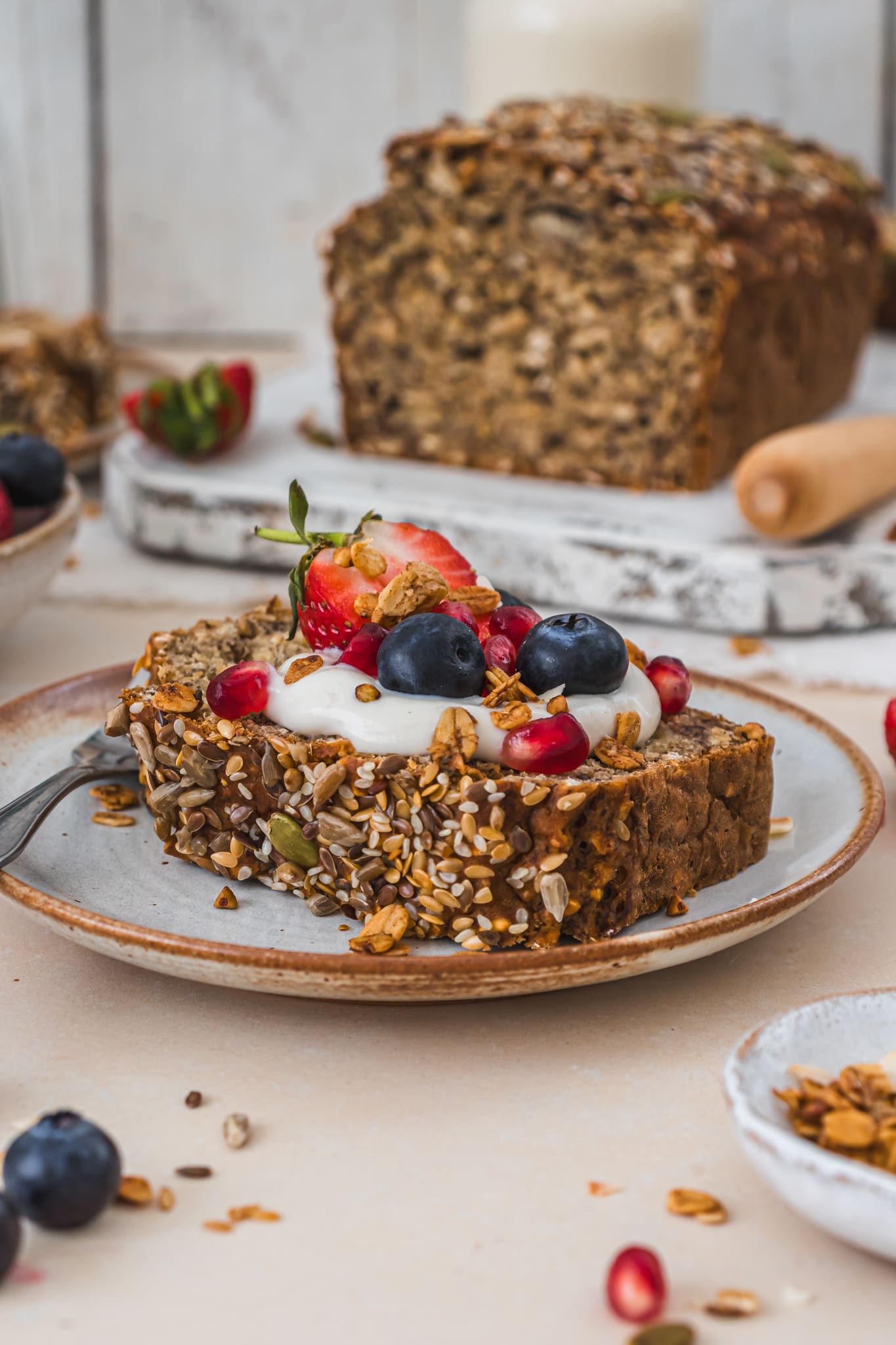 A slice of Espresso Breakfast Banana Bread with fruit and yoghurt