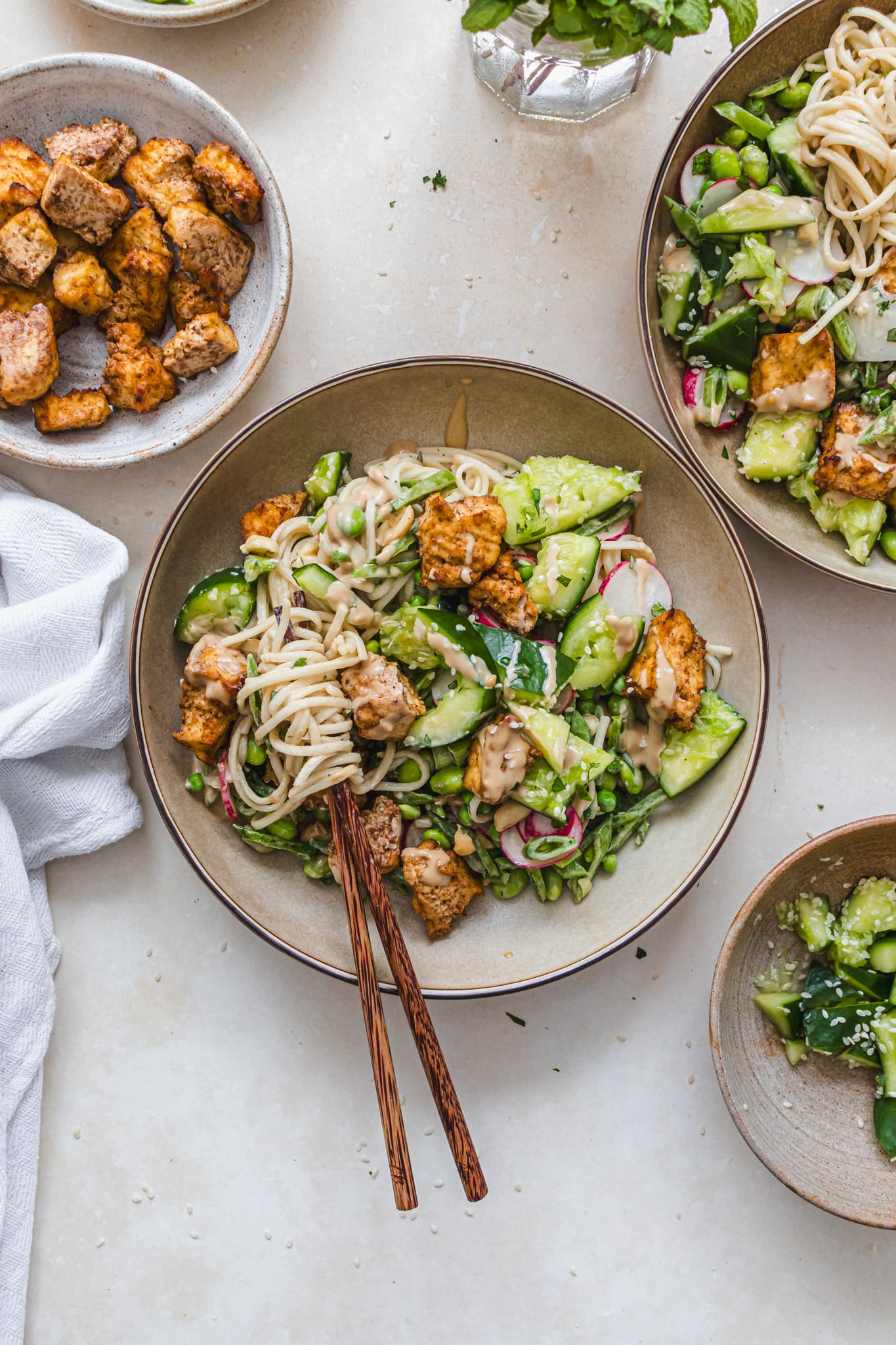 Bowls of Miso Tofu Smashed Cucumber Tahini Noodles with chopsticks