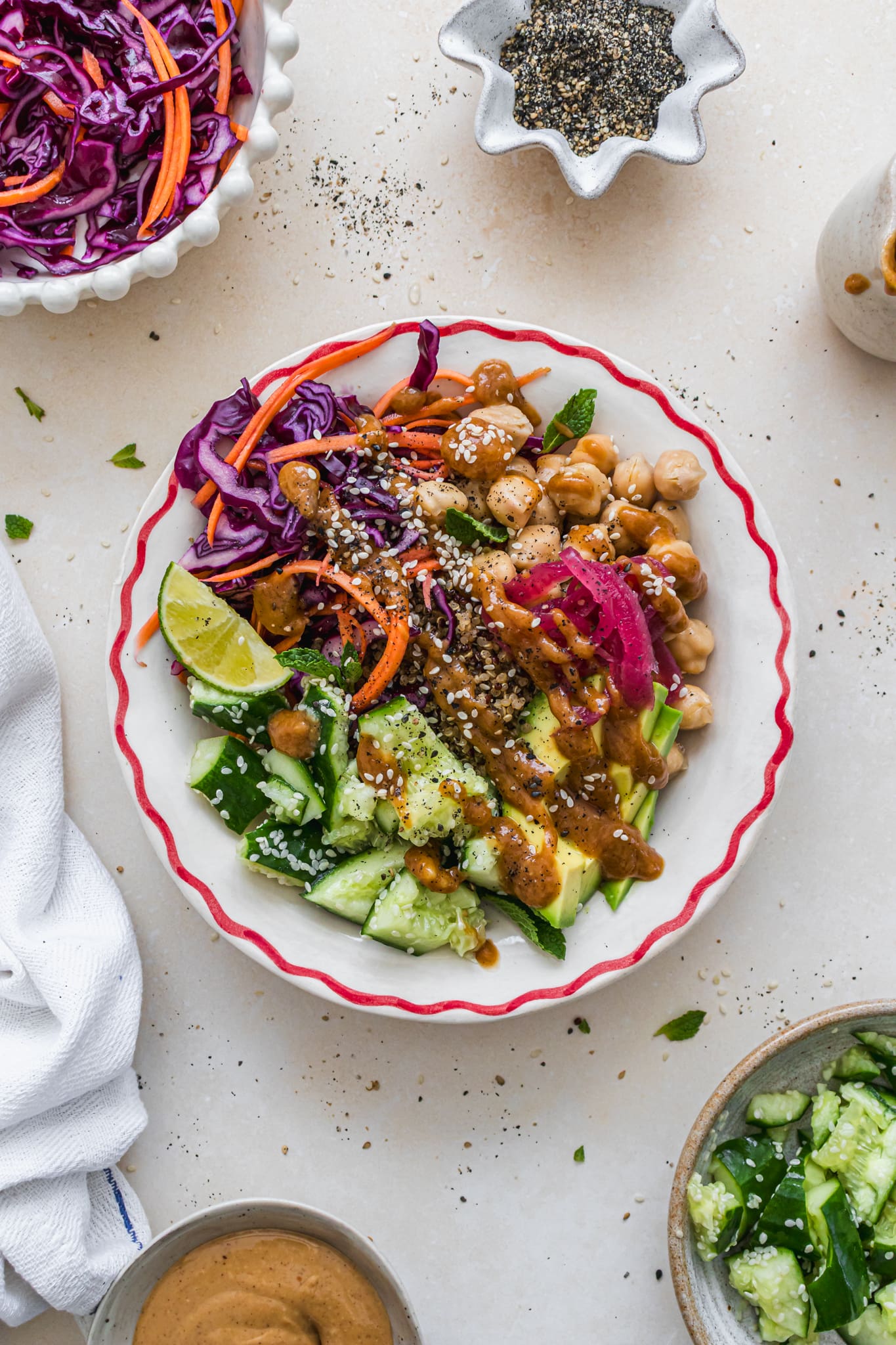 A Chickpea Smashed Cucumber Quinoa Bowl with Satay Sauce