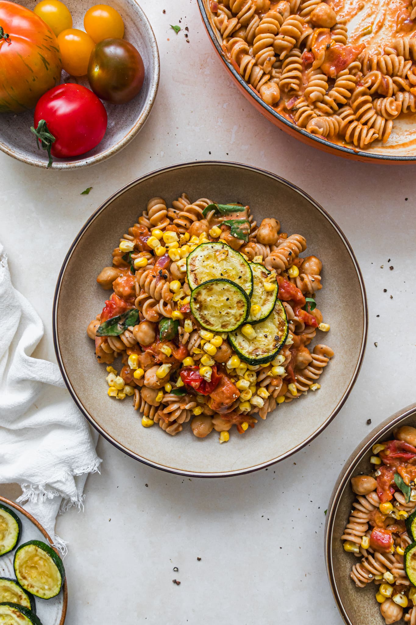 Bowls of Creamy Tomato Sauce Pasta with Courgettes and Corn