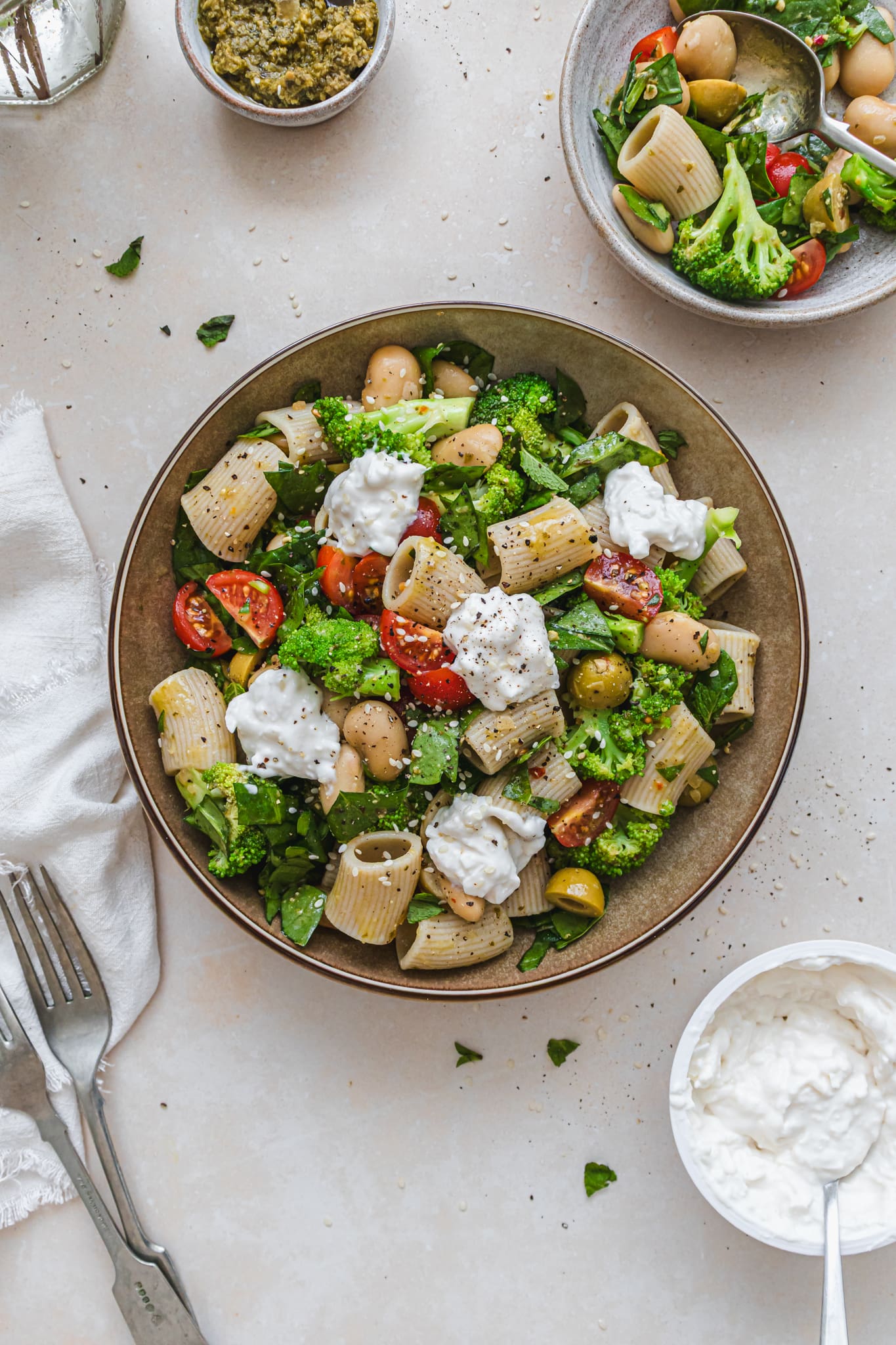A bowl of Tomato Broccoli and Beans Pesto Pasta Salad