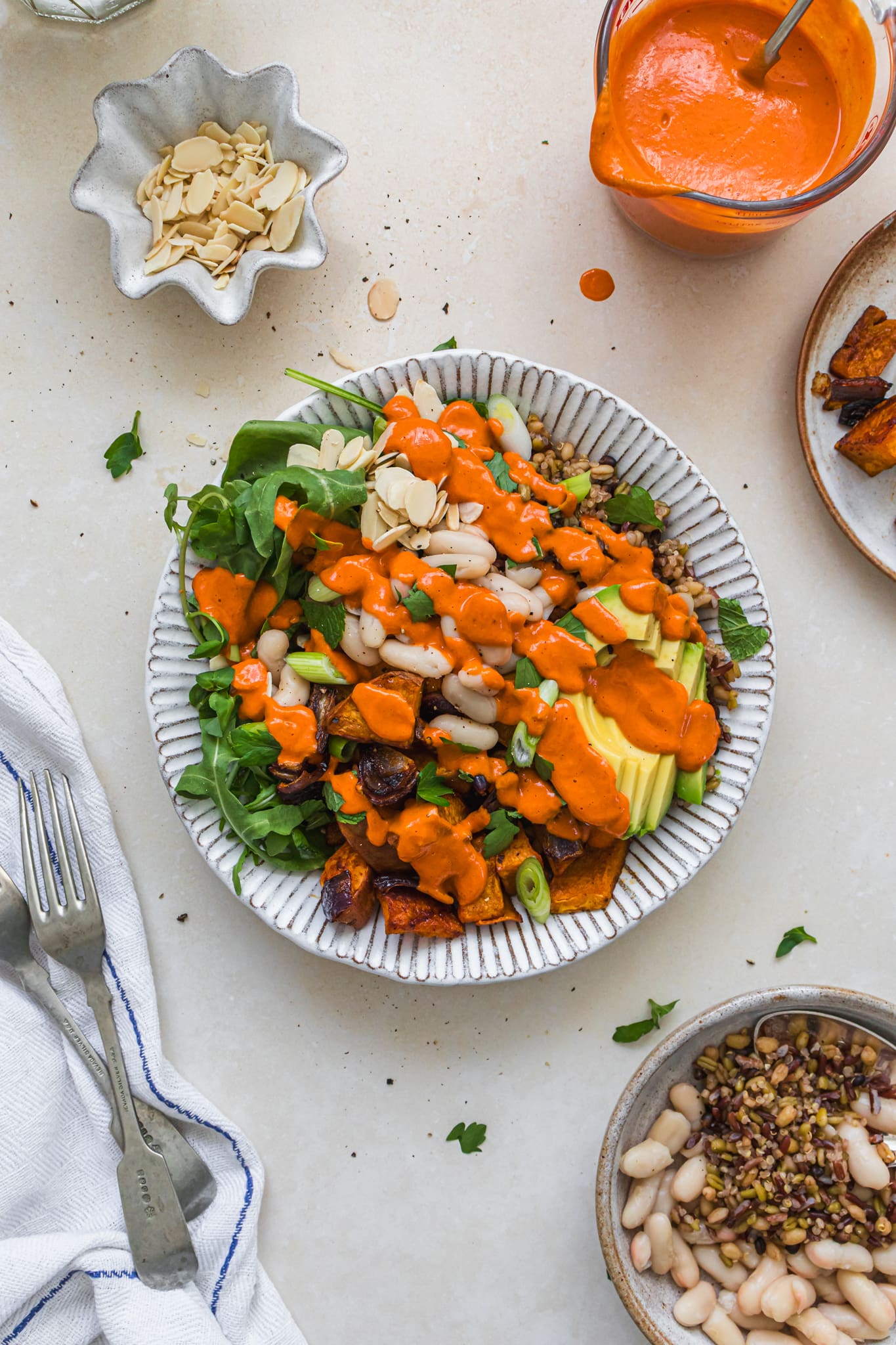 A bowl of Roasted Sweet Potato Butternut Grains with Red Pepper Miso Dressing