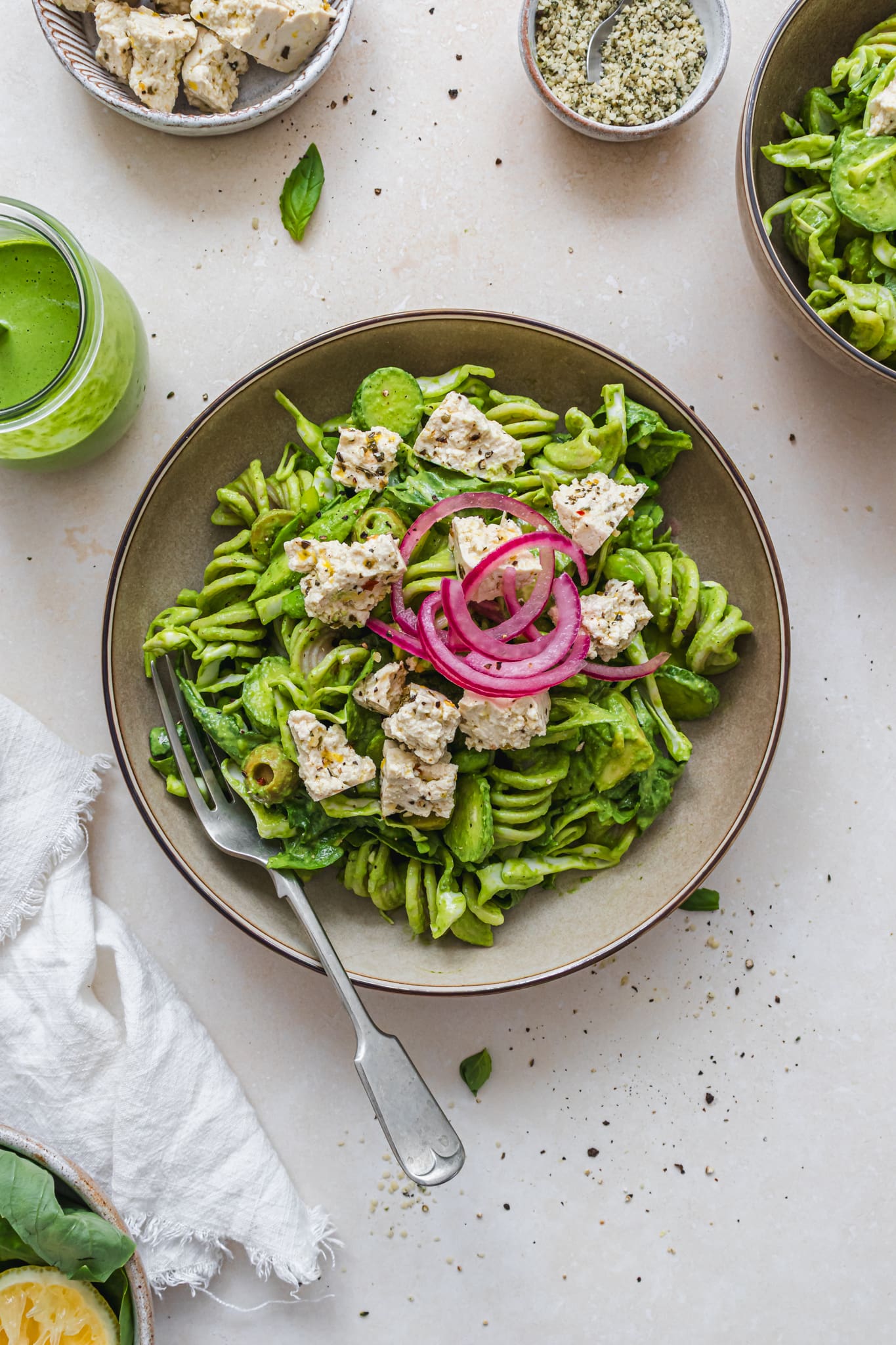 A bowl of Super Greens Pesto Pasta Salad with Tofu Feta with a fork