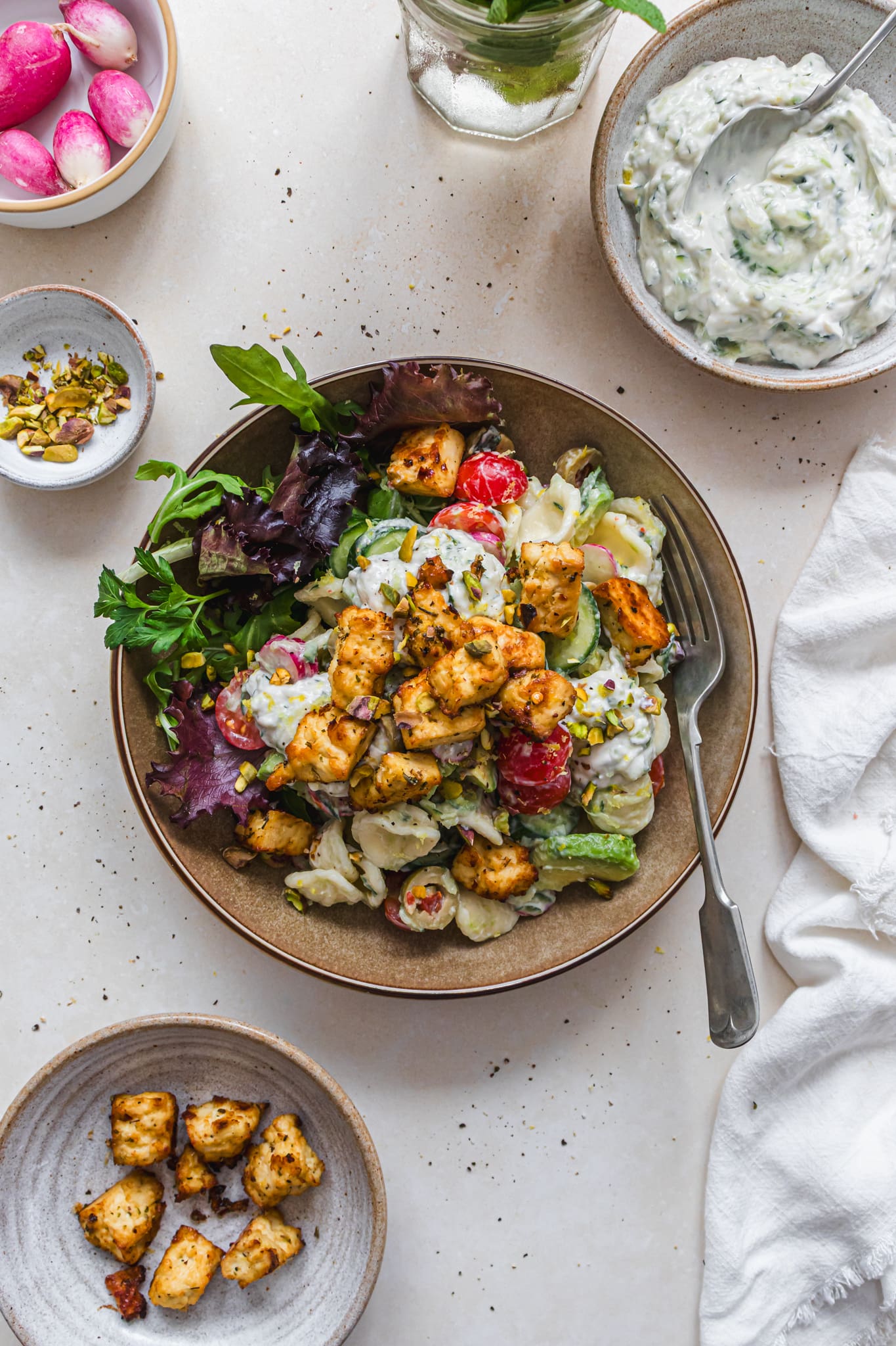 A bowl of Tzatziki Pasta Salad with Lemon Tofu with a fork