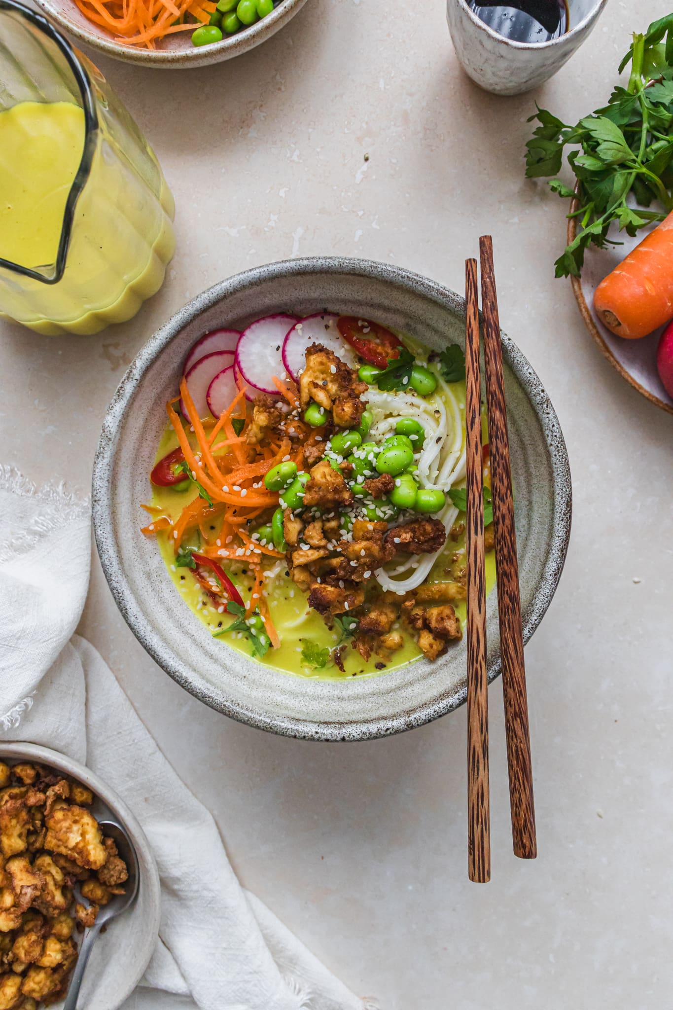 A bowl of Golden Coconut Noodle Soup with Crispy Tofu